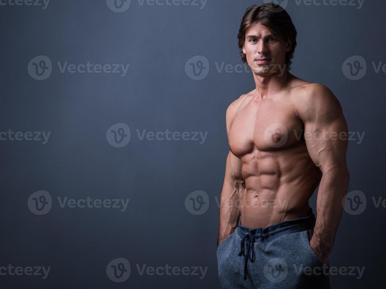 Handsome and muscular man posing in studio photo