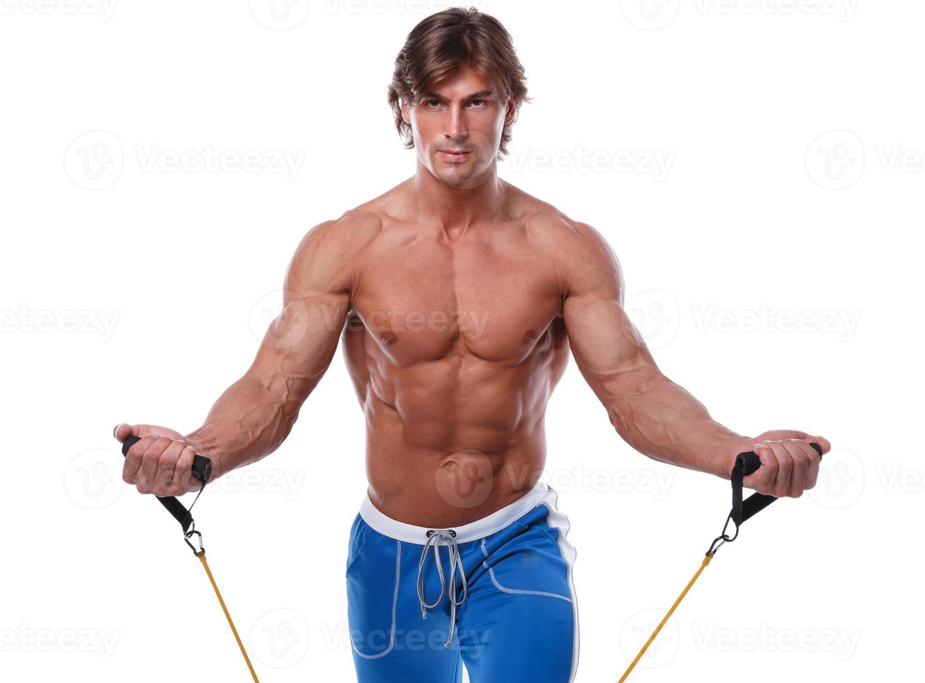 Handsome guy working out with rubber band photo