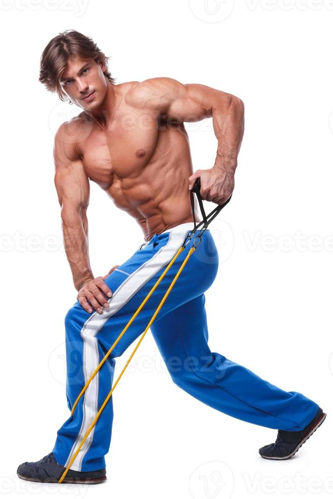 Handsome guy working out with rubber band photo