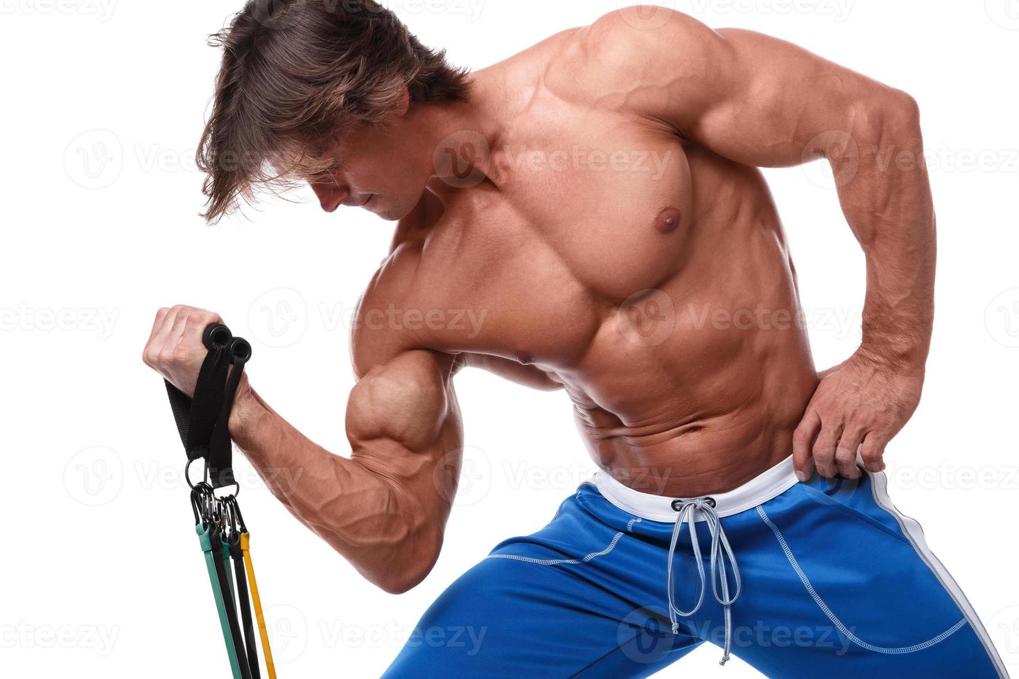 Handsome guy working out with rubber band photo