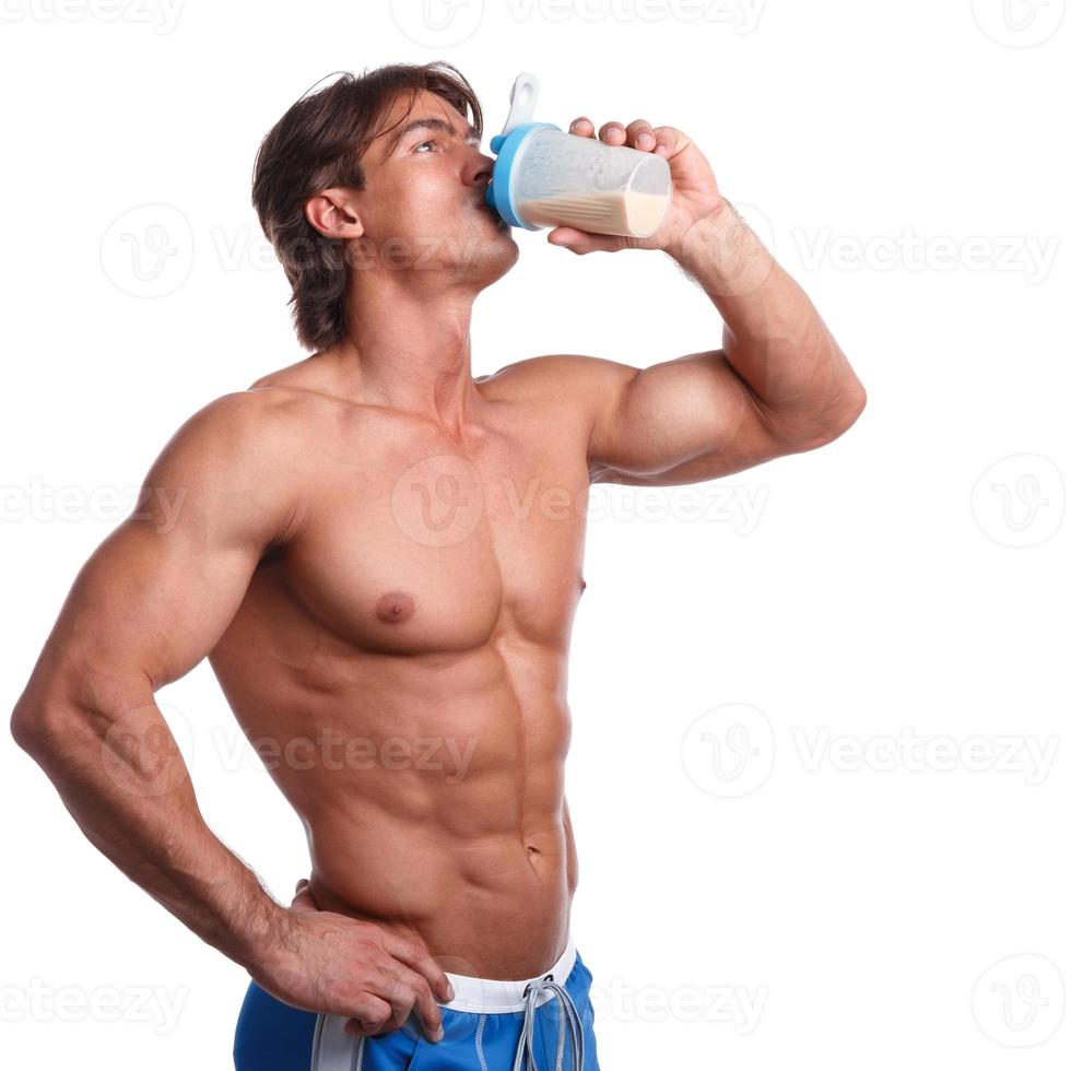 Muscular man with protein drink in shaker photo