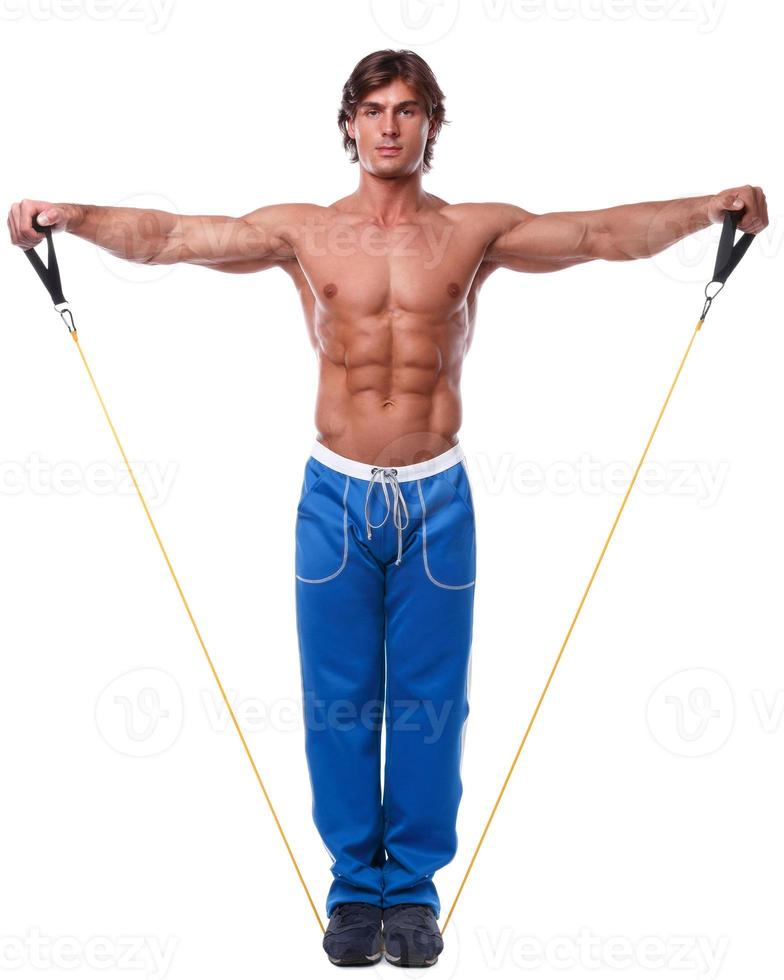 Handsome guy working out with rubber band photo