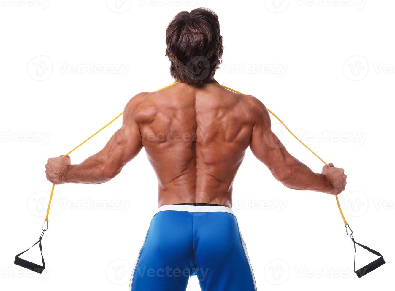 Muscle man working out with rubber band photo