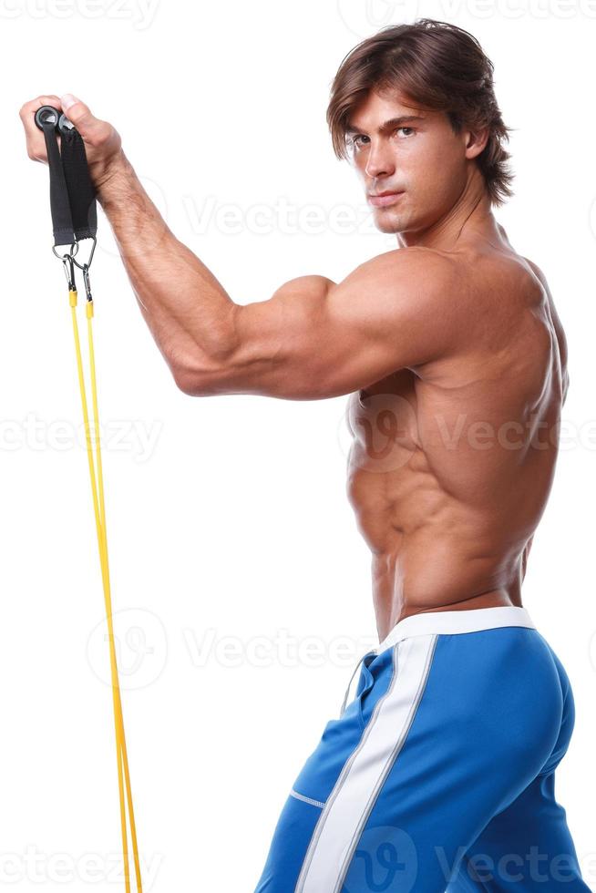 Handsome guy working out with rubber band photo