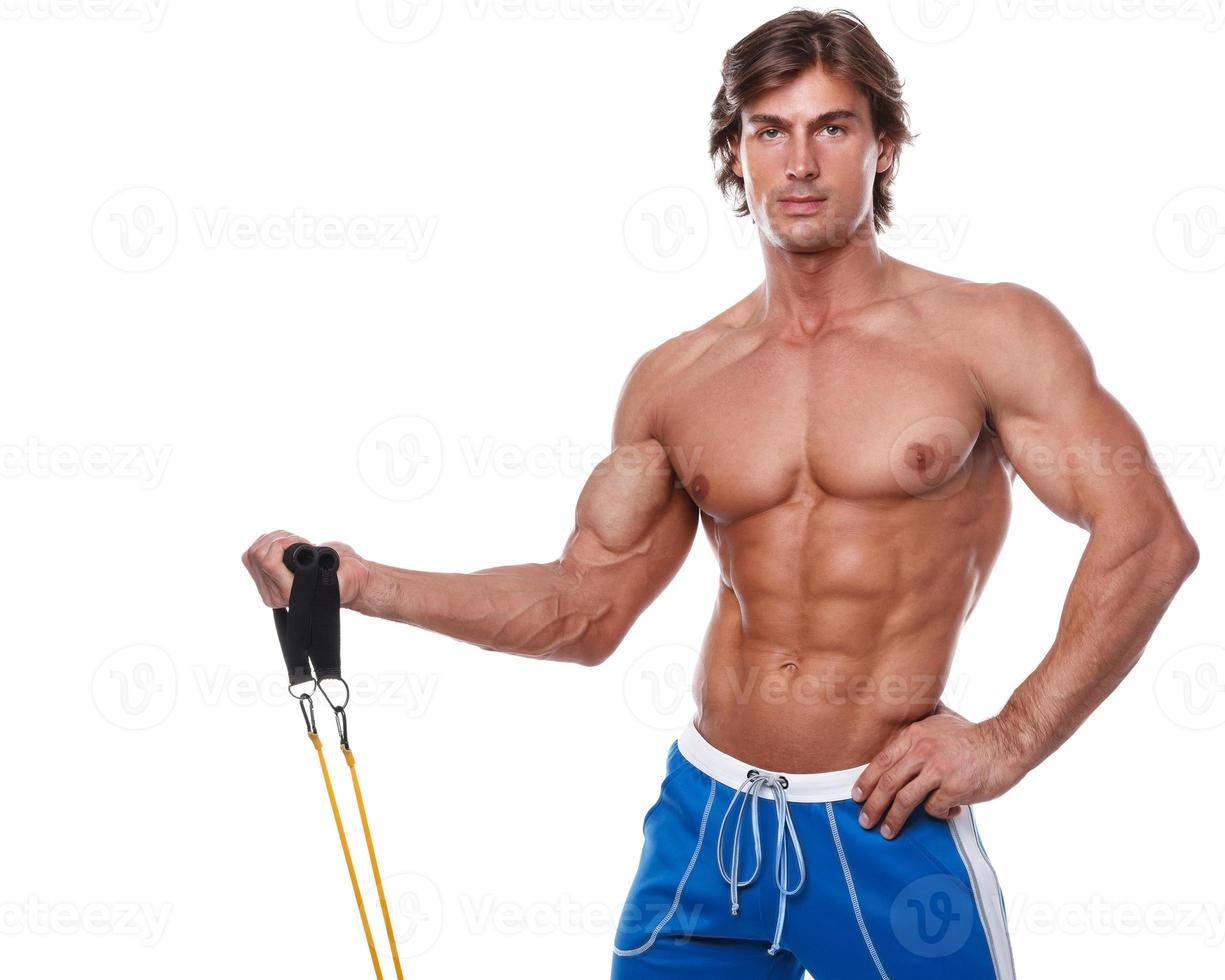 Handsome guy working out with rubber band photo