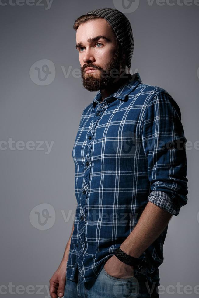 Portrait of handsome bearded man in checkered shirt photo