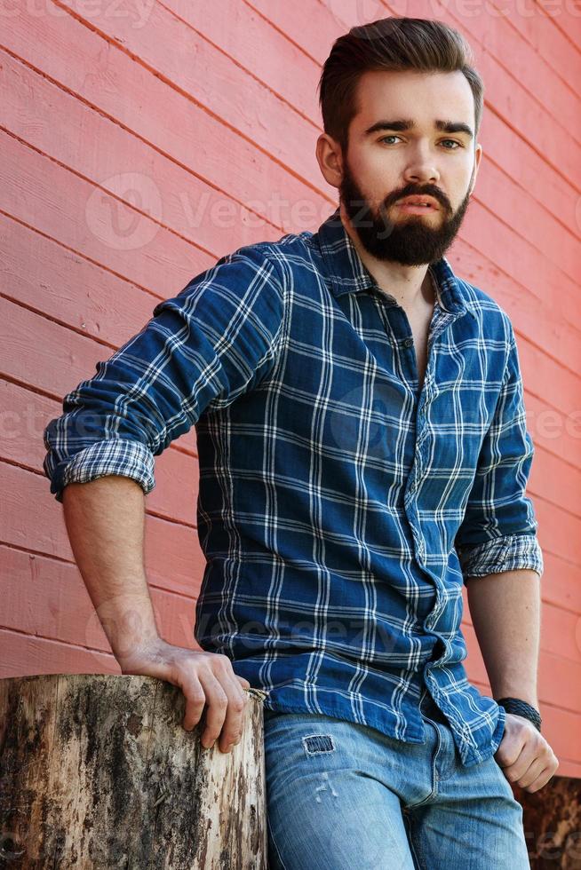 Portrait of handsome bearded man in checkered shirt photo