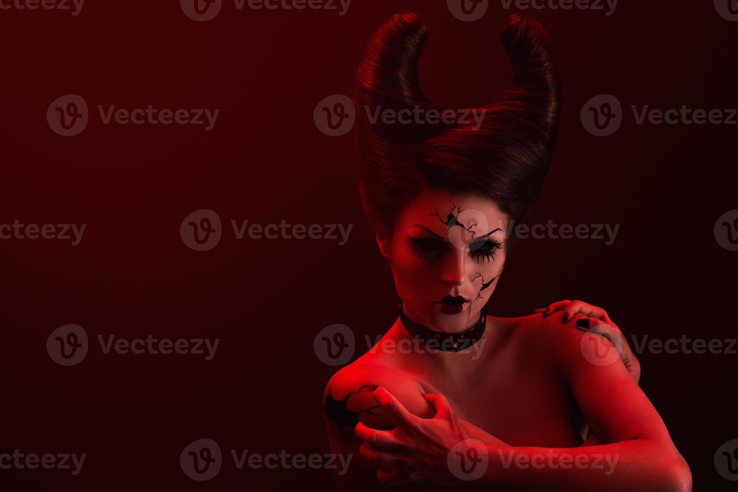Talking broken doll with horns on her head photo
