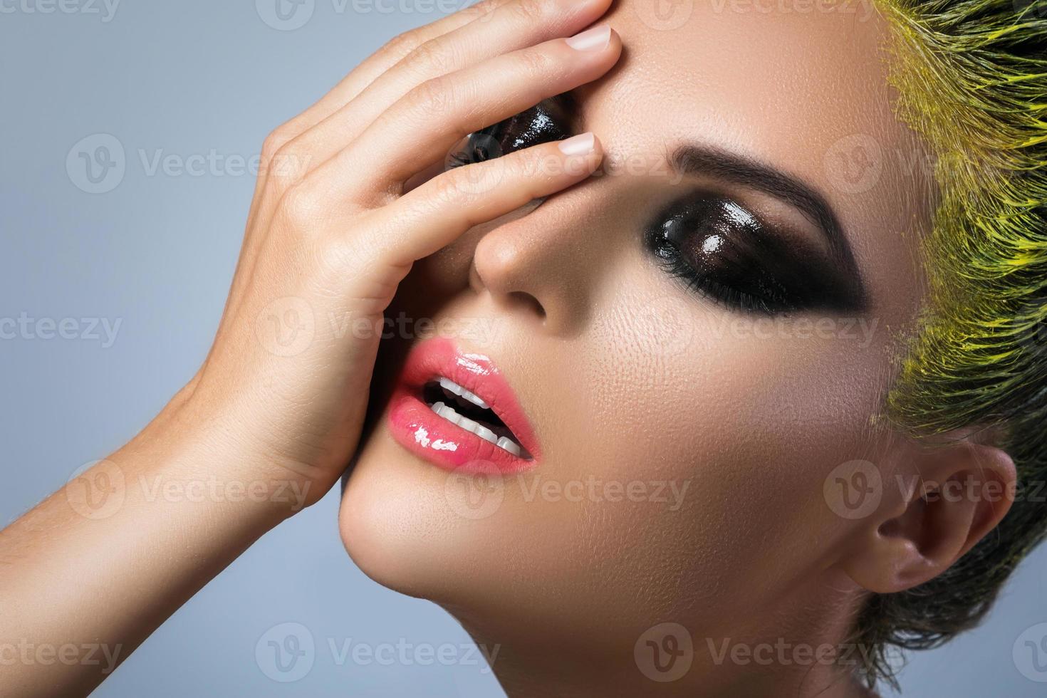 Woman with wet eyeshadows and yellow hair photo