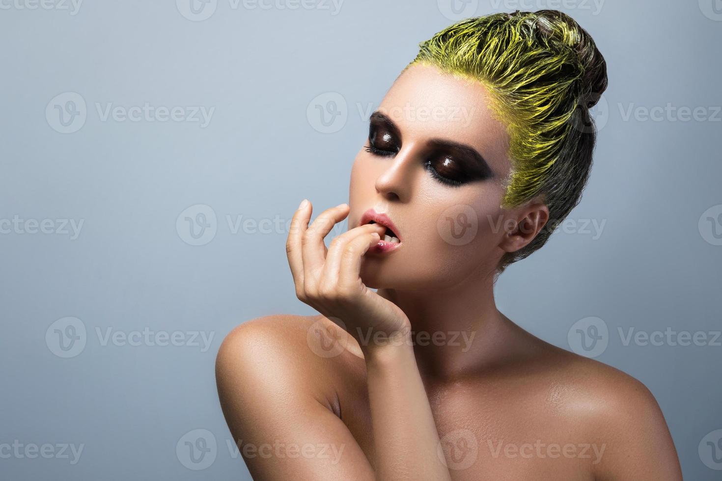 Woman with wet eyeshadows and yellow hair photo