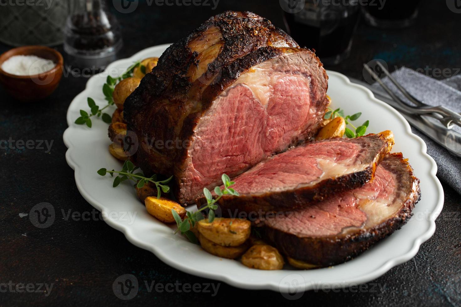 Boneless beef roast on a serving platter sliced photo