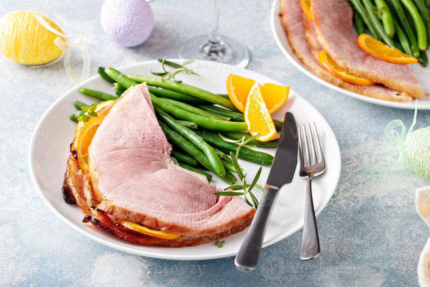 Easter baked ham served on a plate with green beans photo