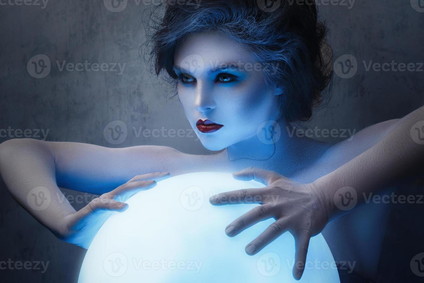 Woman in creative makeup and body-art in image of a soothsayer photo