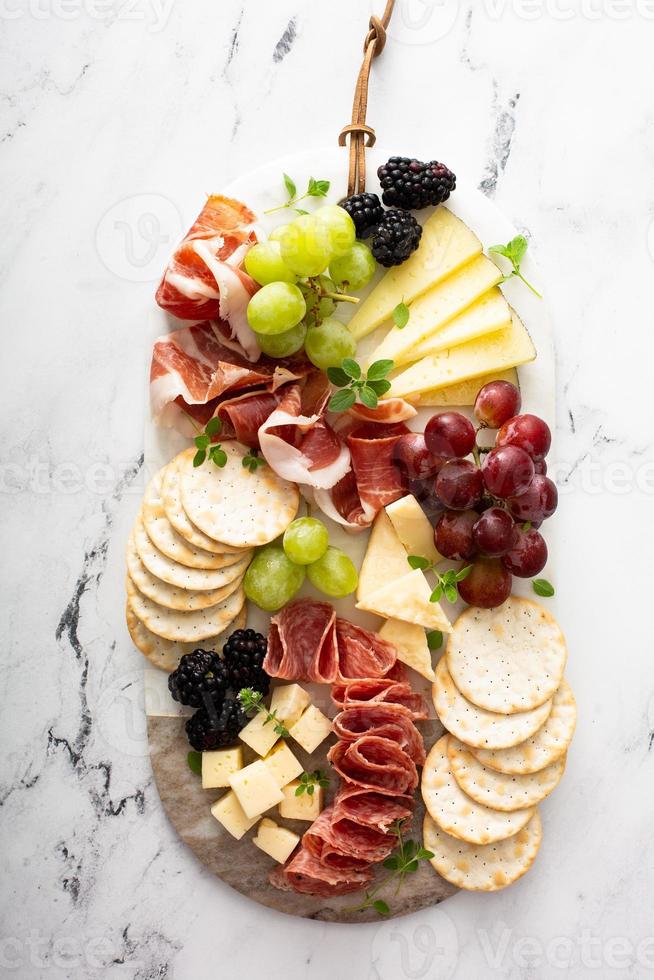 Charcuterie board with variety of cheese and meat photo