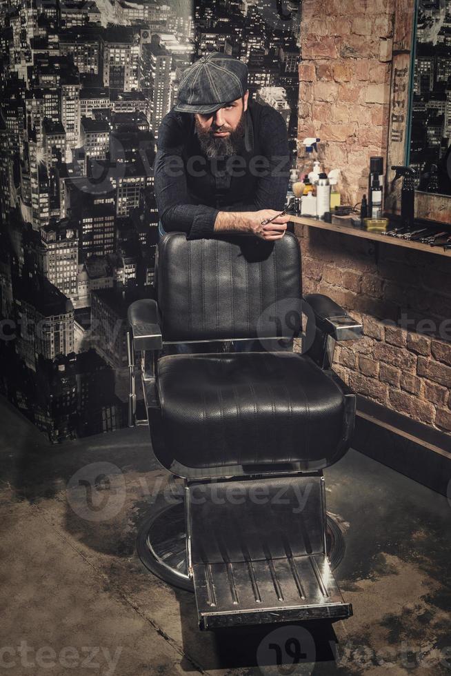 Portrait of stylish hairdresser man in his studio photo