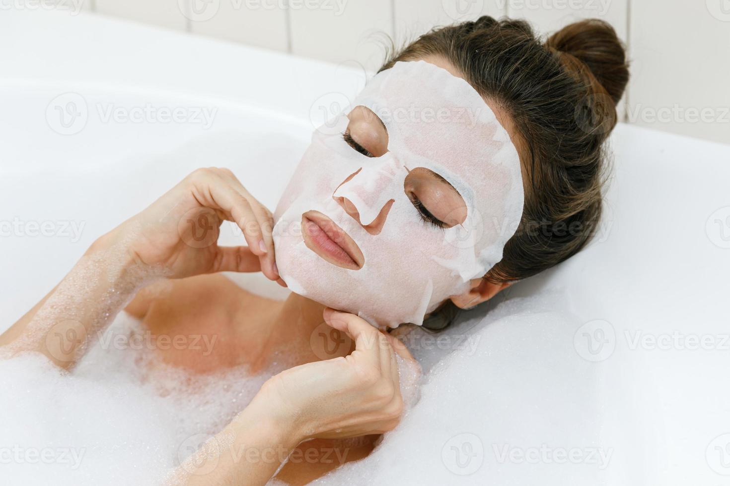 Woman with sheet mask on her face photo