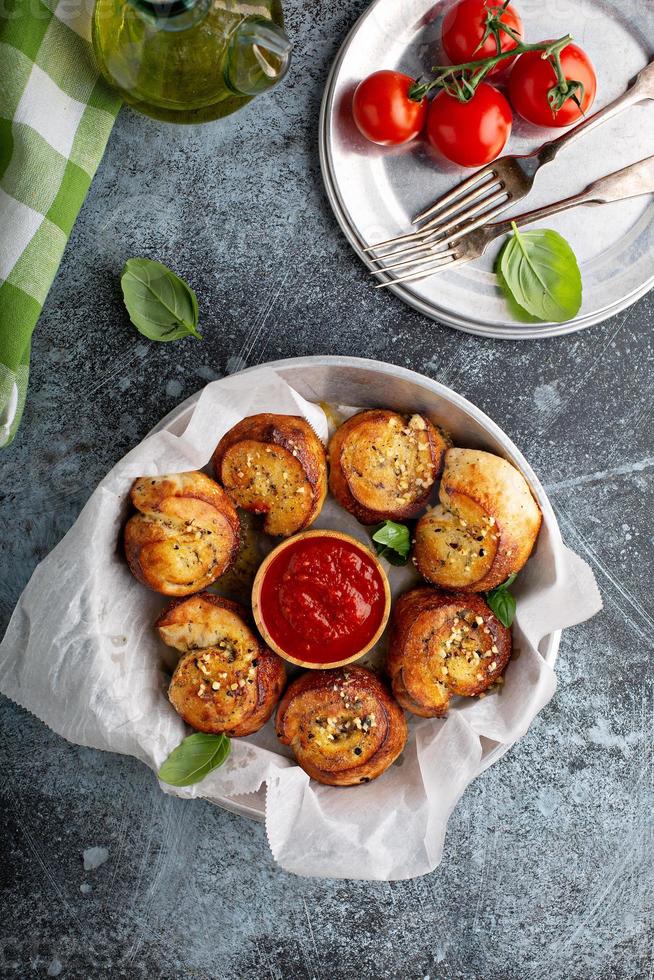 Garlic dinner rolls with marinara sauce photo