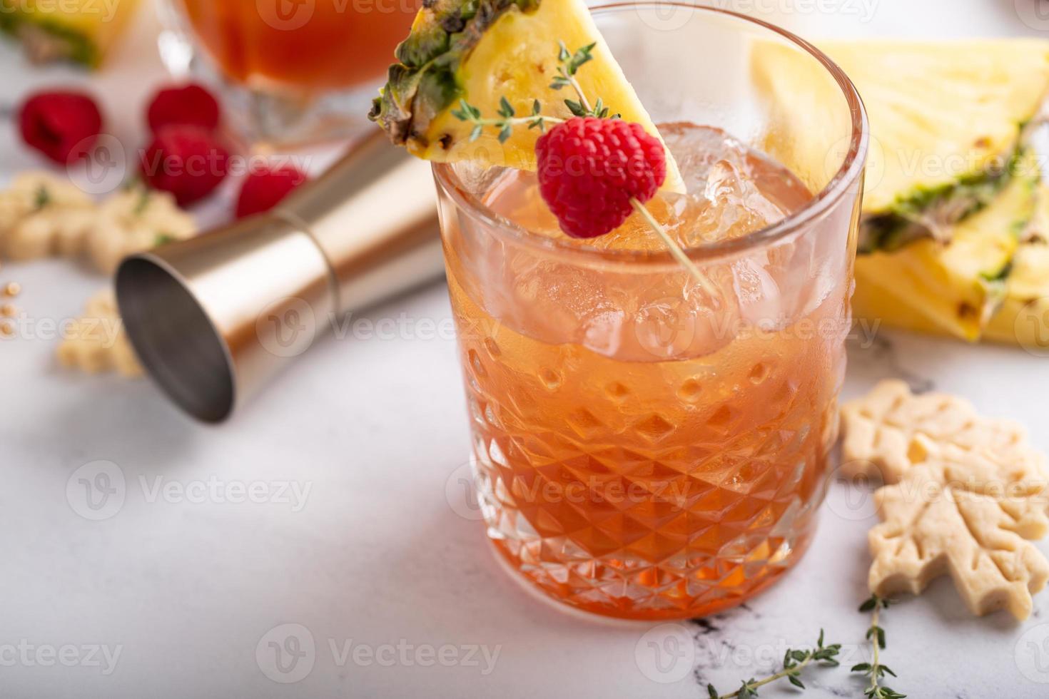 Raspberry pineapple refreshing cocktail with thyme sprig photo