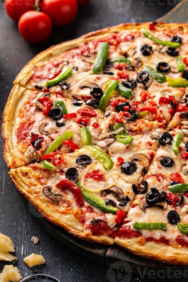 Vegetarian pizza with peppers, mushrooms and olives photo