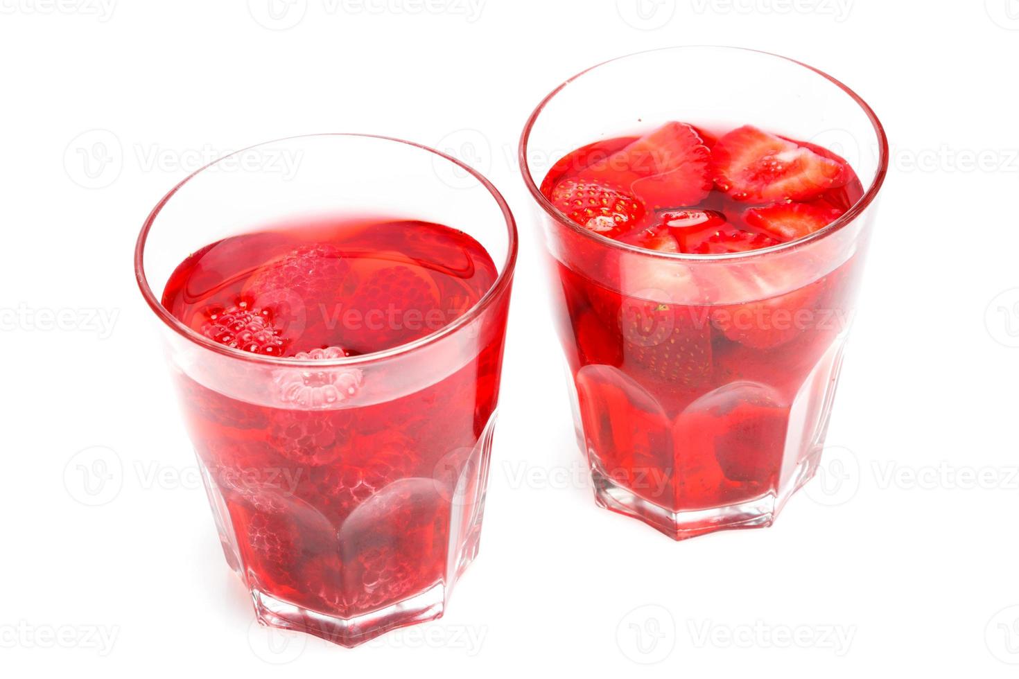 Glasses of drink of strawberry and raspberry on white background photo