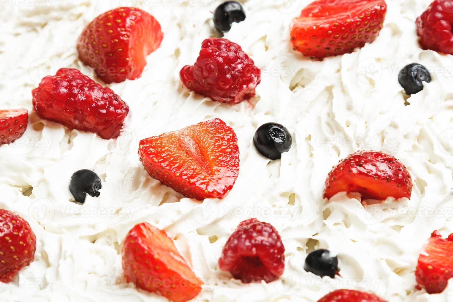 Strawberry, raspberry and blueberry in sweet whipped cream photo