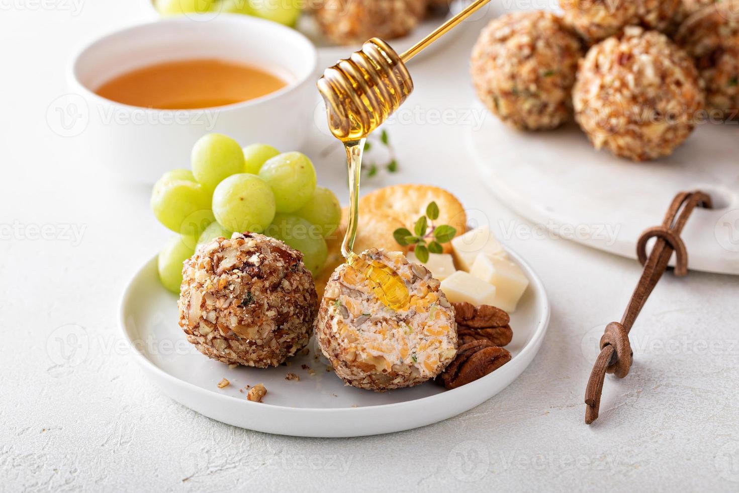 Cheese balls or truffles on a cheese board with crackers photo