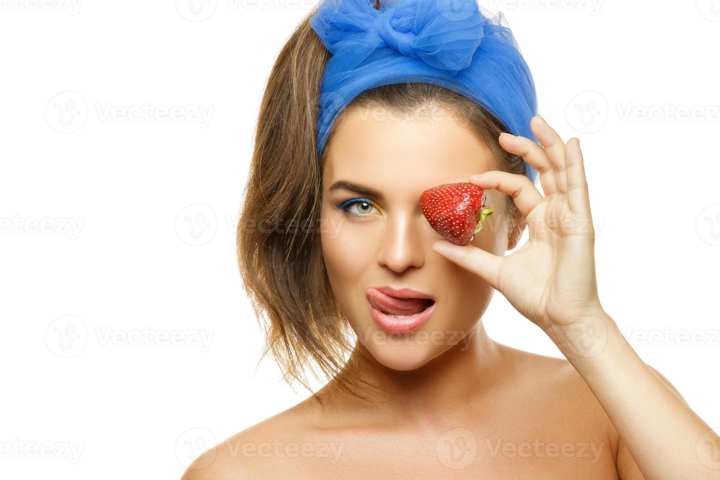 Beautiful woman with colorful make-up and strawberry photo
