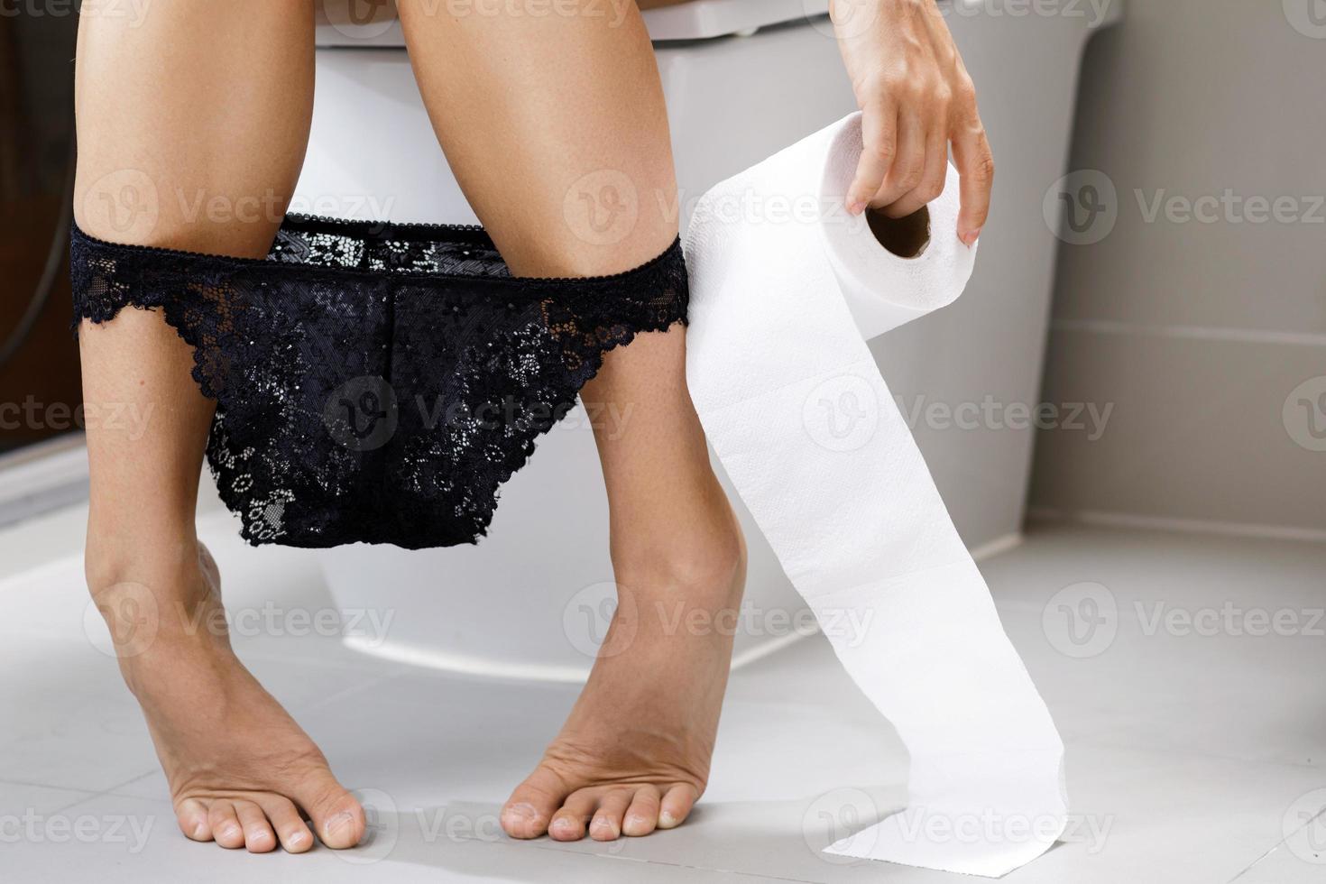 A beautiful girl is sitting on the toilet. Woman in panties relaxing on the  toilet with the phone. Pensive teenage girl sits with panties on the  toilet. 11025526 Stock Photo at Vecteezy