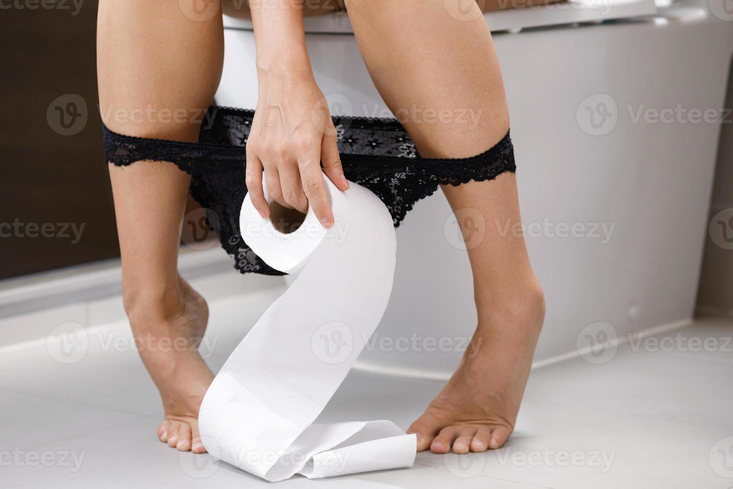 Woman with a roll of toilet paper in her hand photo