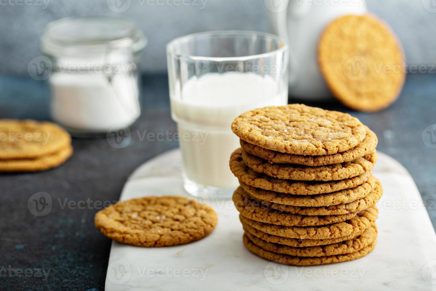 Thin and chewy molasses cookies with milk photo