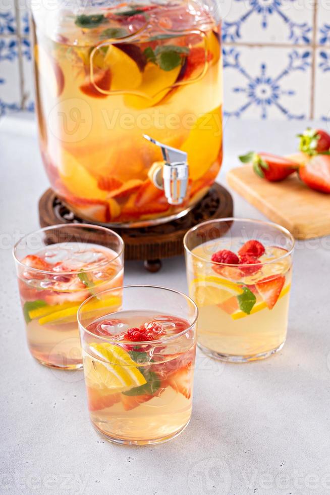 Summer sangria punch in a pitcher and glasses photo