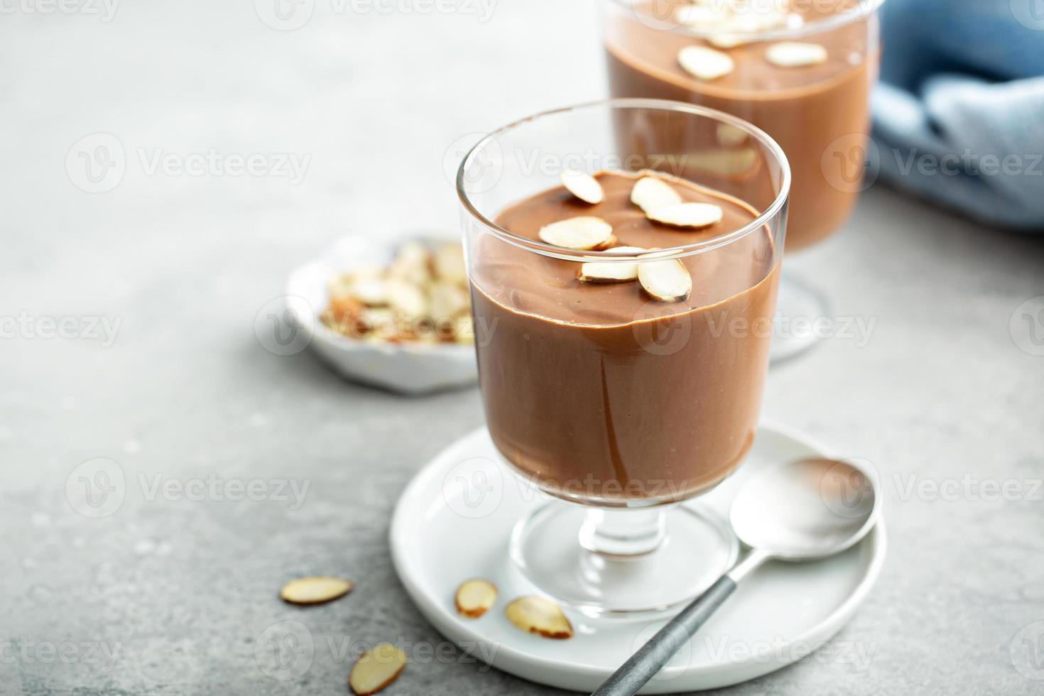 Chocolate pudding with sliced almonds photo