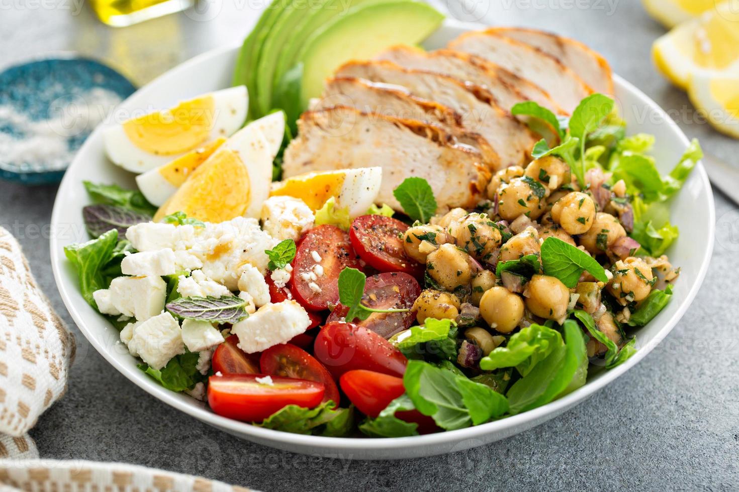 Healthy grilled chicken lunch bowl with chickpeas and feta photo