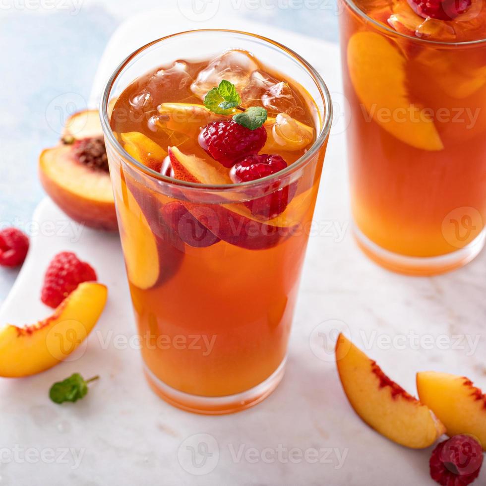 Peach and raspberry iced tea or cocktail photo