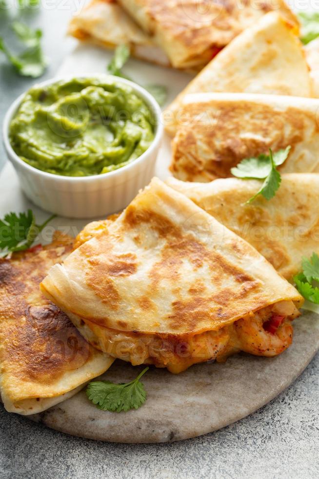 Shrimp and cheese quesadillas served with guacamole photo