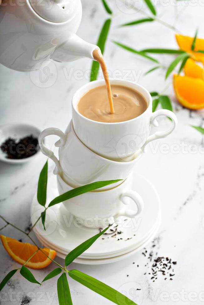 Earl grey milk tea poured in stacked cups photo