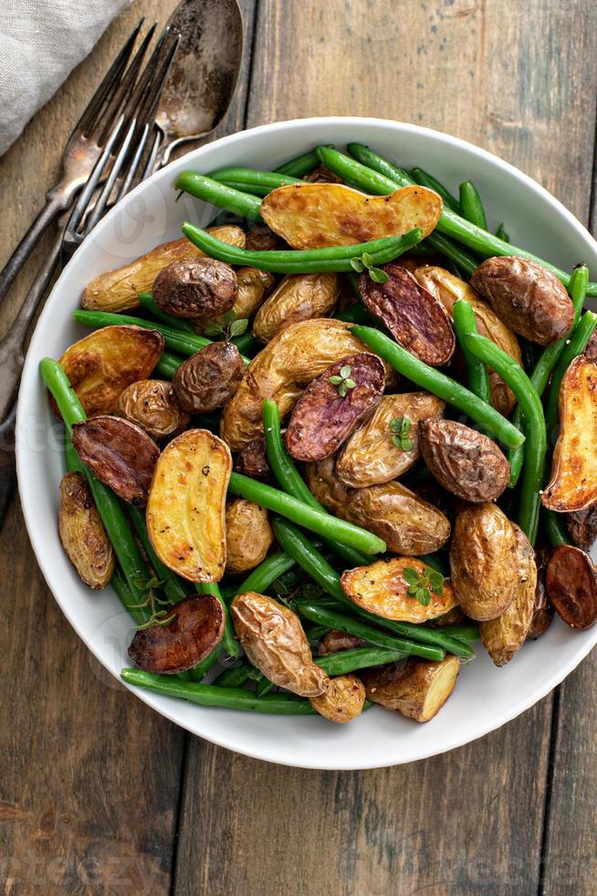 Roasted crispy fingerling potatoes with green beans n a serving bowl photo