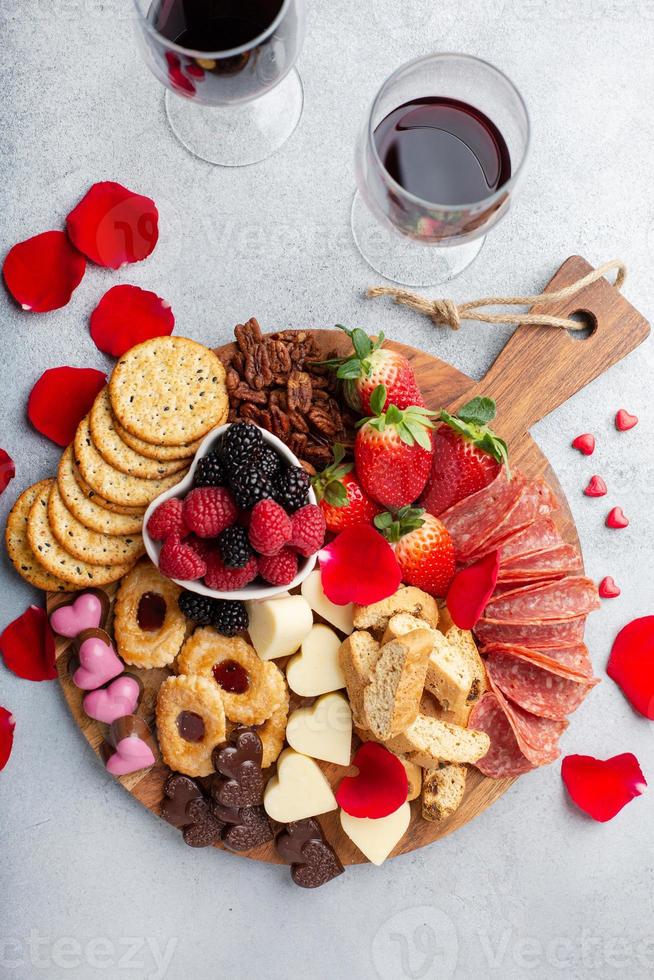 Cheese plate for Valentines day with snacks and fruit photo