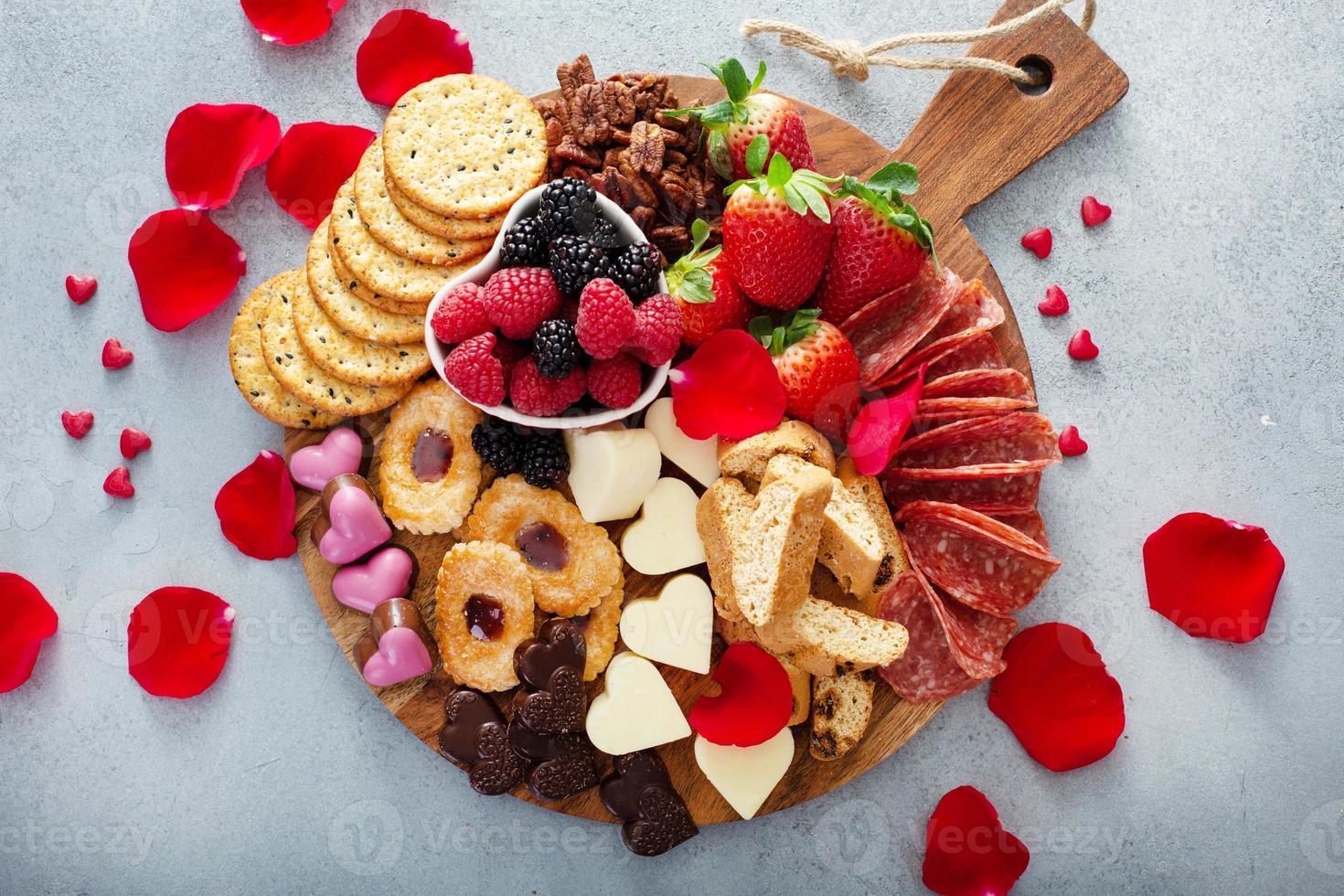 Cheese plate for Valentines day with snacks and fruit photo