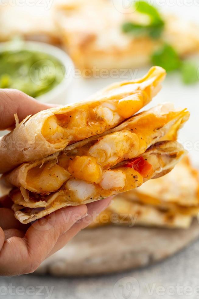 Shrimp and cheese quesadillas served with guacamole photo