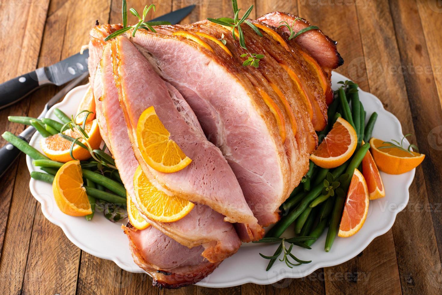 Christmas or Thanksgiving spiral sliced ham with oranges and herbs photo