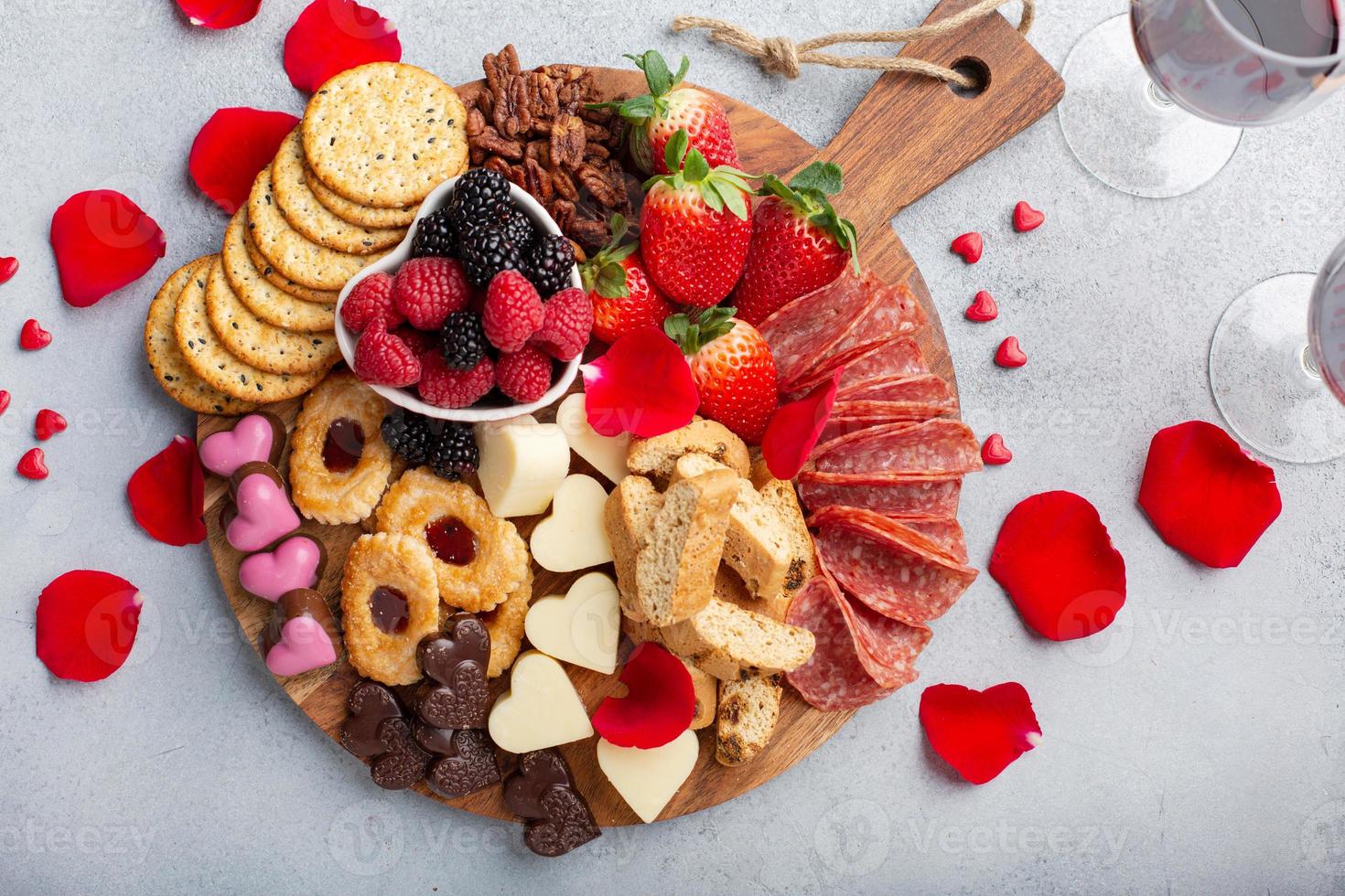 Cheese plate for Valentines day with snacks and fruit photo