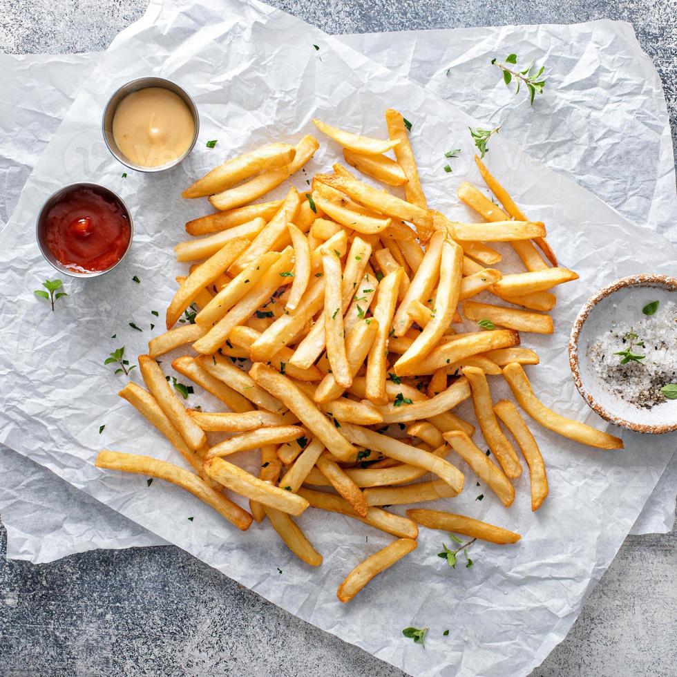 Traditional french fries with ketchup and honey mustard sauce photo