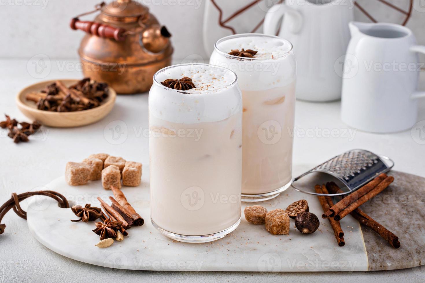 Iced chai latte with warm winter spices topped with milk foam photo