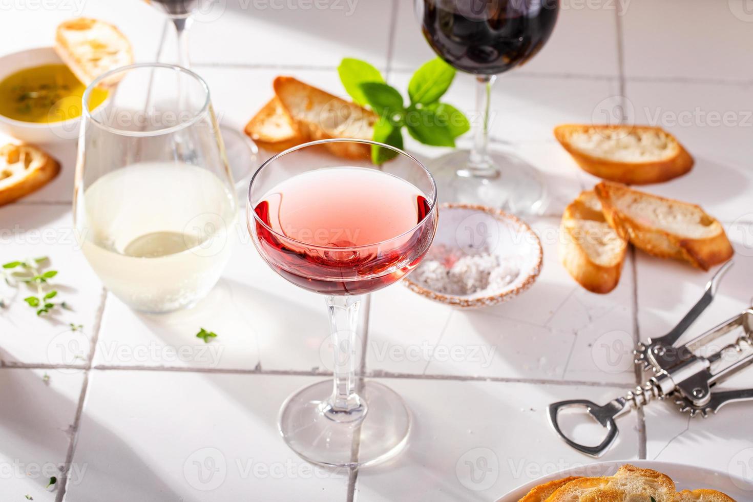 Variety of wine glasses with red, white and rose wine photo