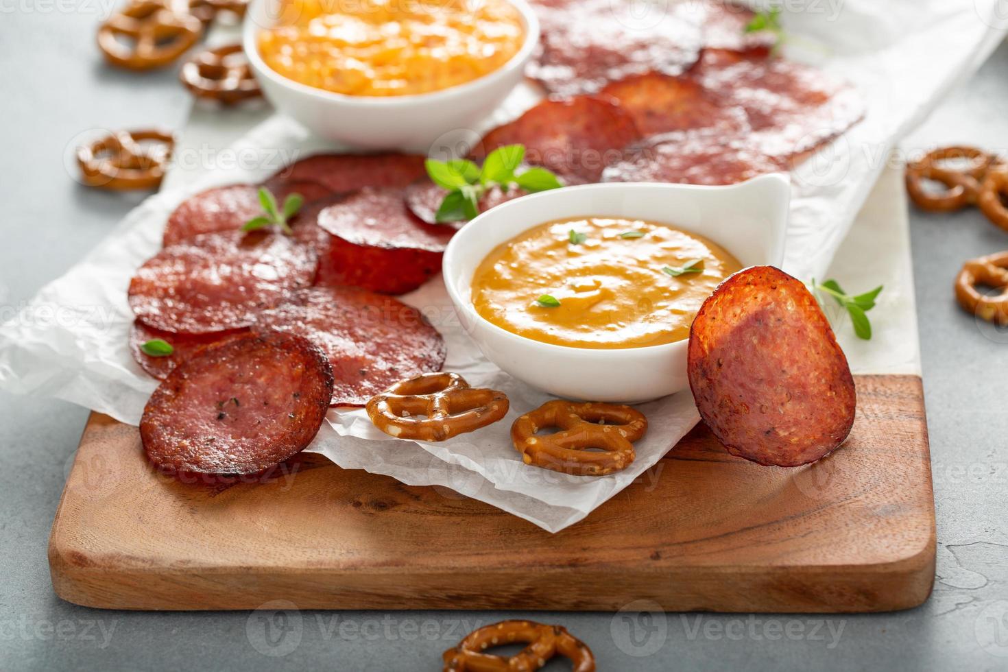 Salami chips baked in the oven with cheese sauces photo