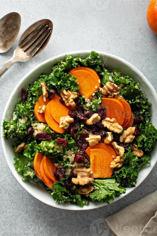 Fall or winter salad with persimmon and kale photo