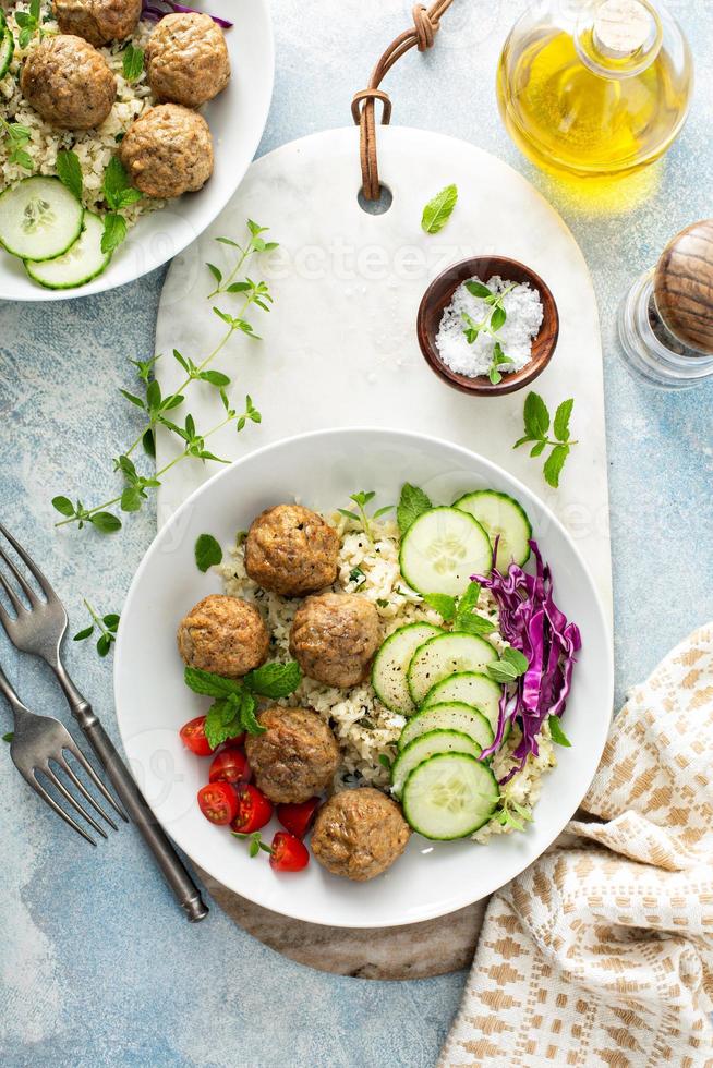 Healthy lunch bowl with meatballs and cauliflower rice photo