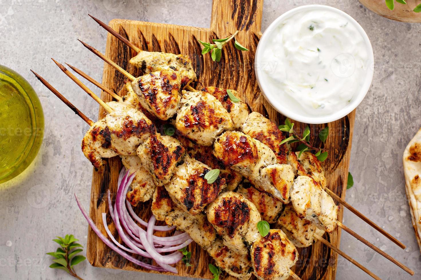 Greek chicken souvlaki on wooden skewers photo