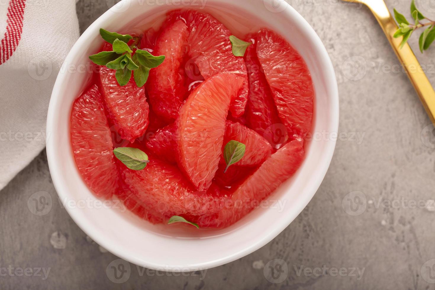 Fresh grapefruit slices in a bowl photo